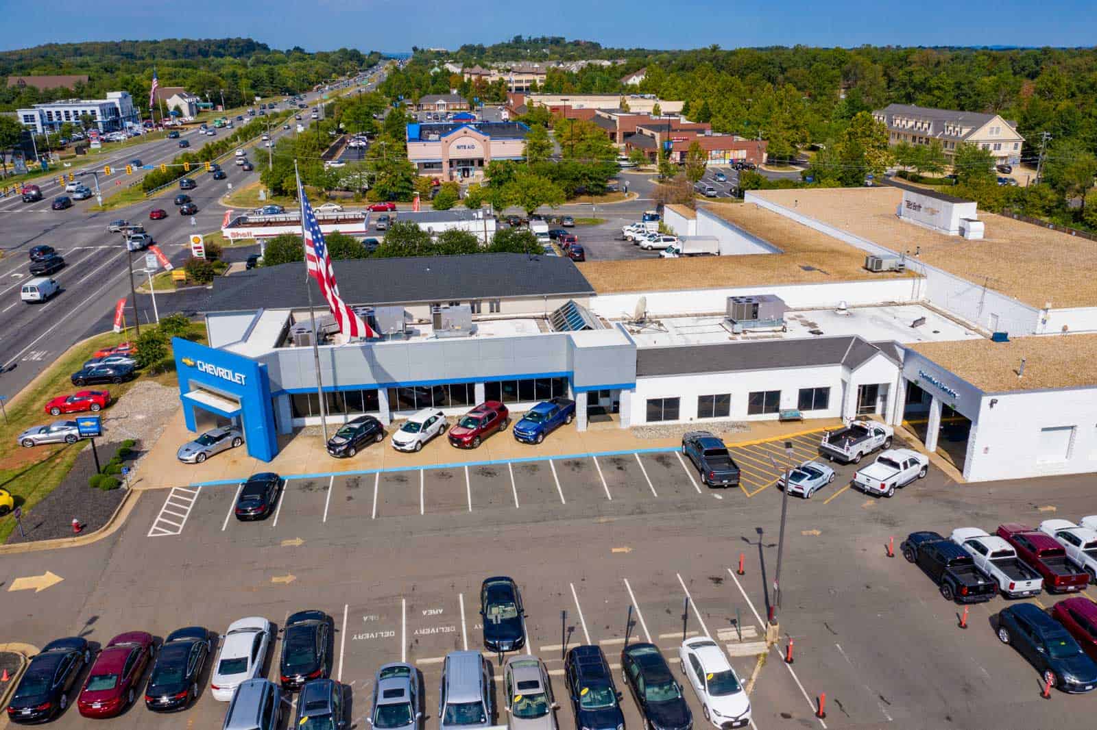 drone photo of Chevrolet dealership entrance with large American flag in Sterling, VA